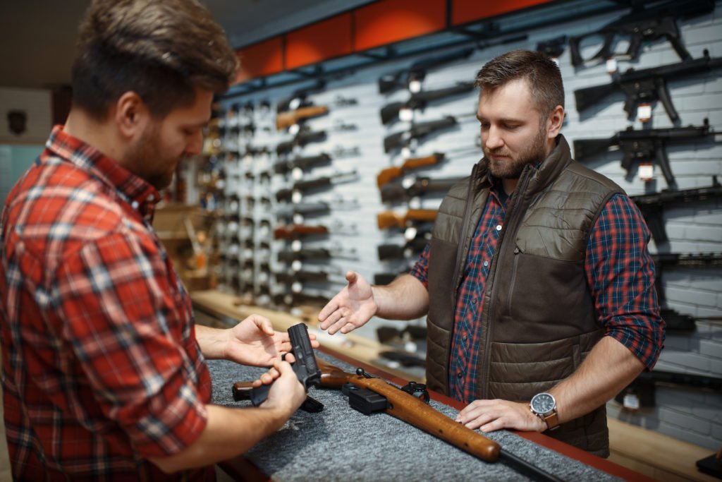 Man buying handgun from dealer.