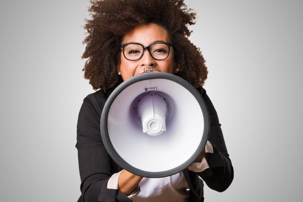 A woman violating NRS 203.090 by speaking into a megaphone at a meeting.