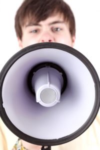 A person with a megaphone illegally disrupting a lawful assembly. 