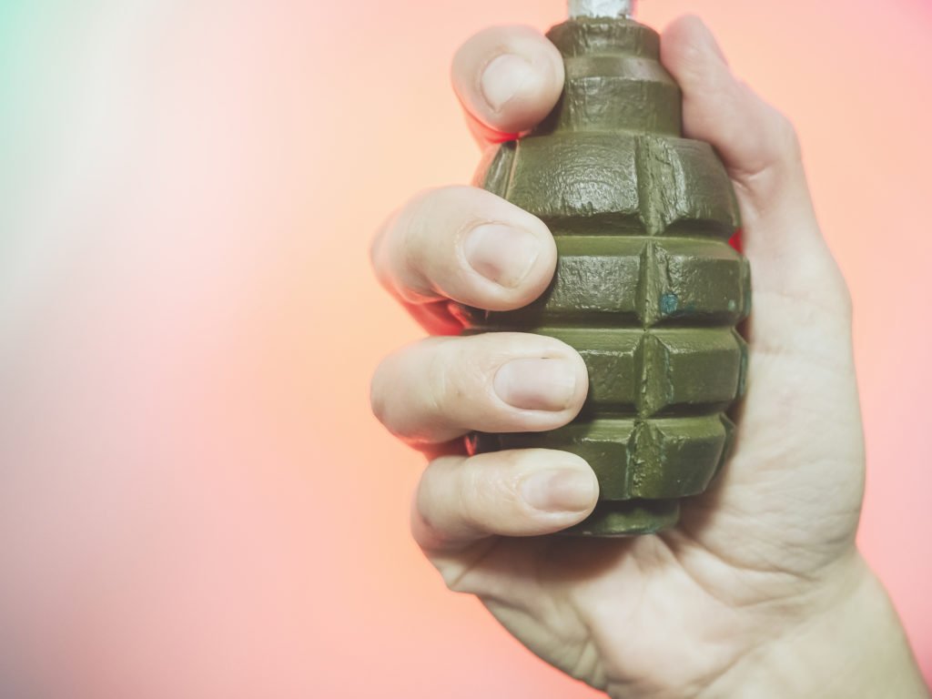Hand holding grenade in violation of Colorado law