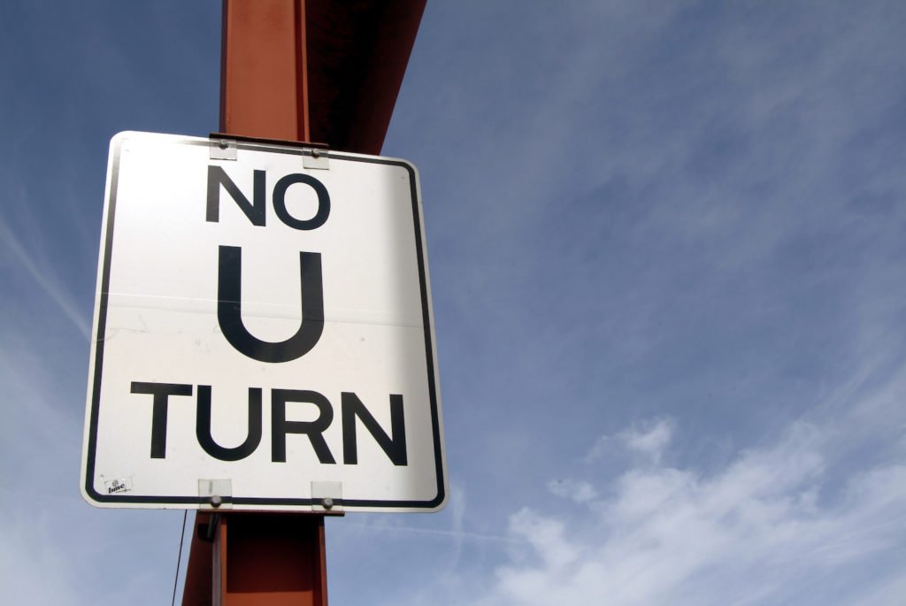 No U Turn sign with sky in background