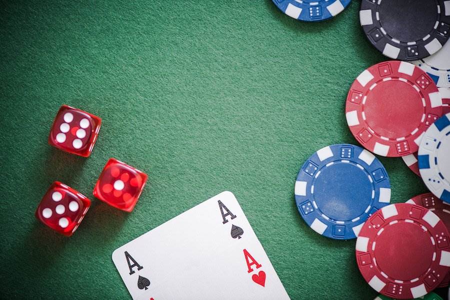 chips, dice, card on green table