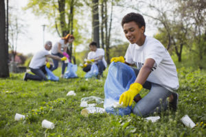 A young man cleaning up a park for community service.