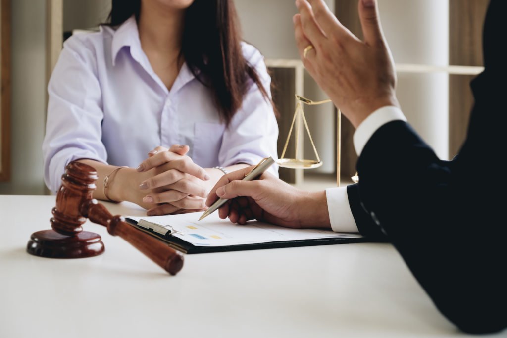 Employee meeting with attorney with a gavel and scale of justice