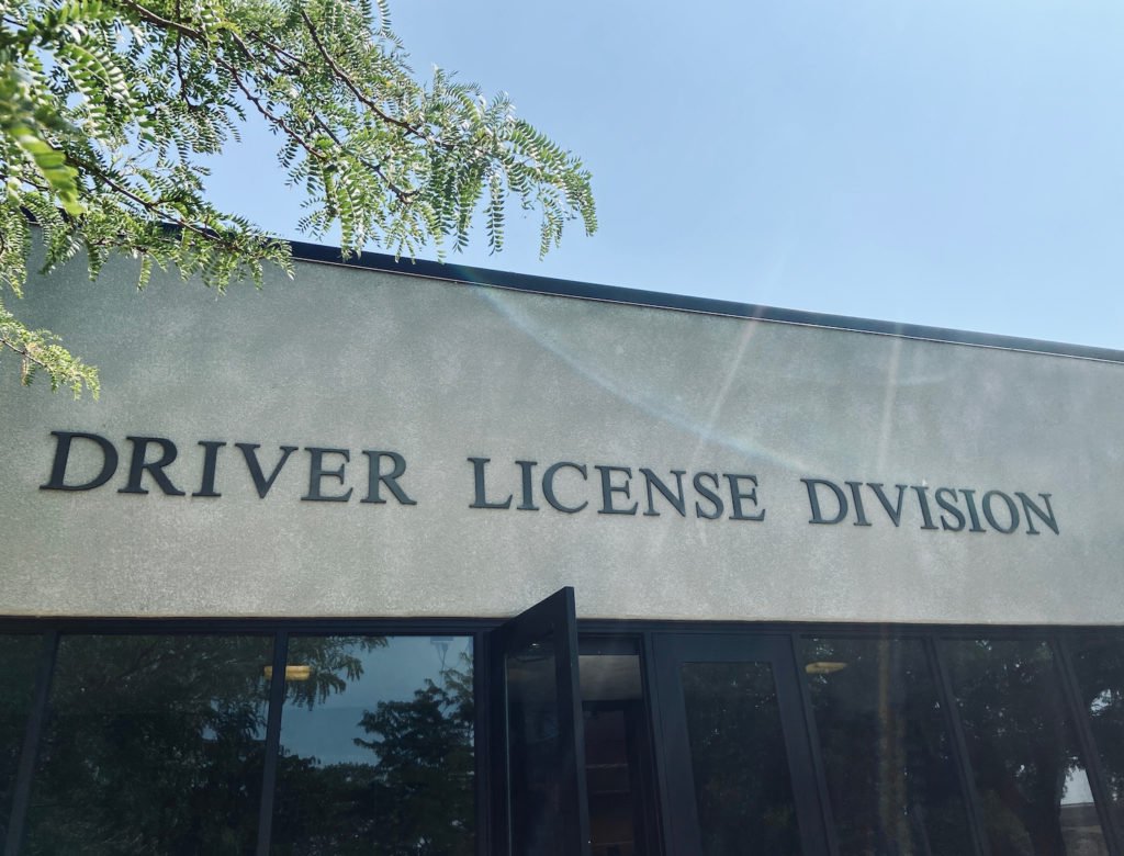 DMV entrance with tree in foreground as an example of the location of a DMV license suspension hearing