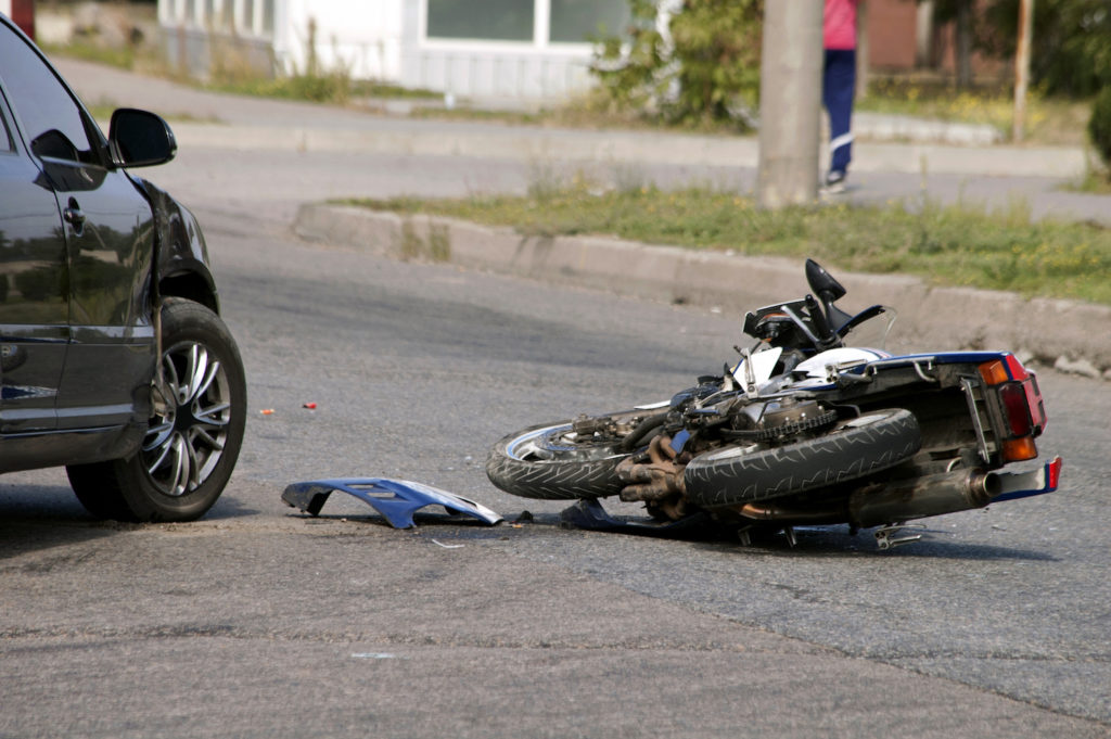 Parked car and motorcycle that was crashed into - victims in California can file a motorcycle accident lawsuit