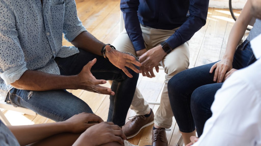 Close-up of rehab patients in a circle