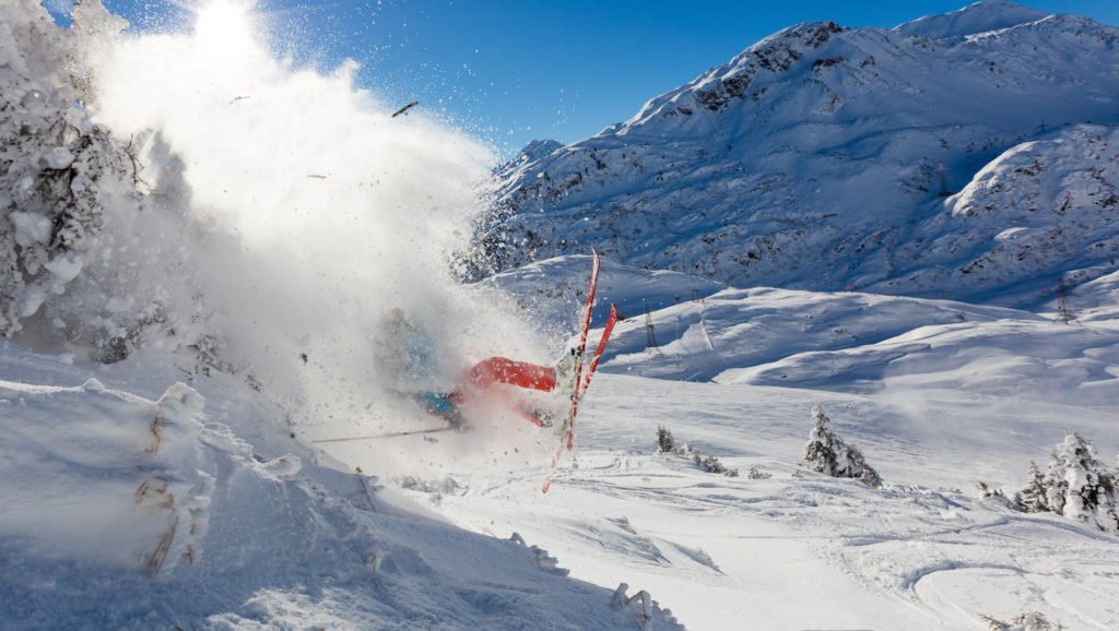 Skier falling down on snowy mountain