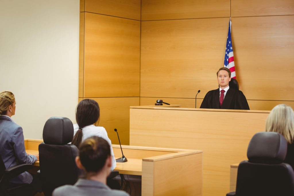 Courtroom with judge, defense attorney, and defendant