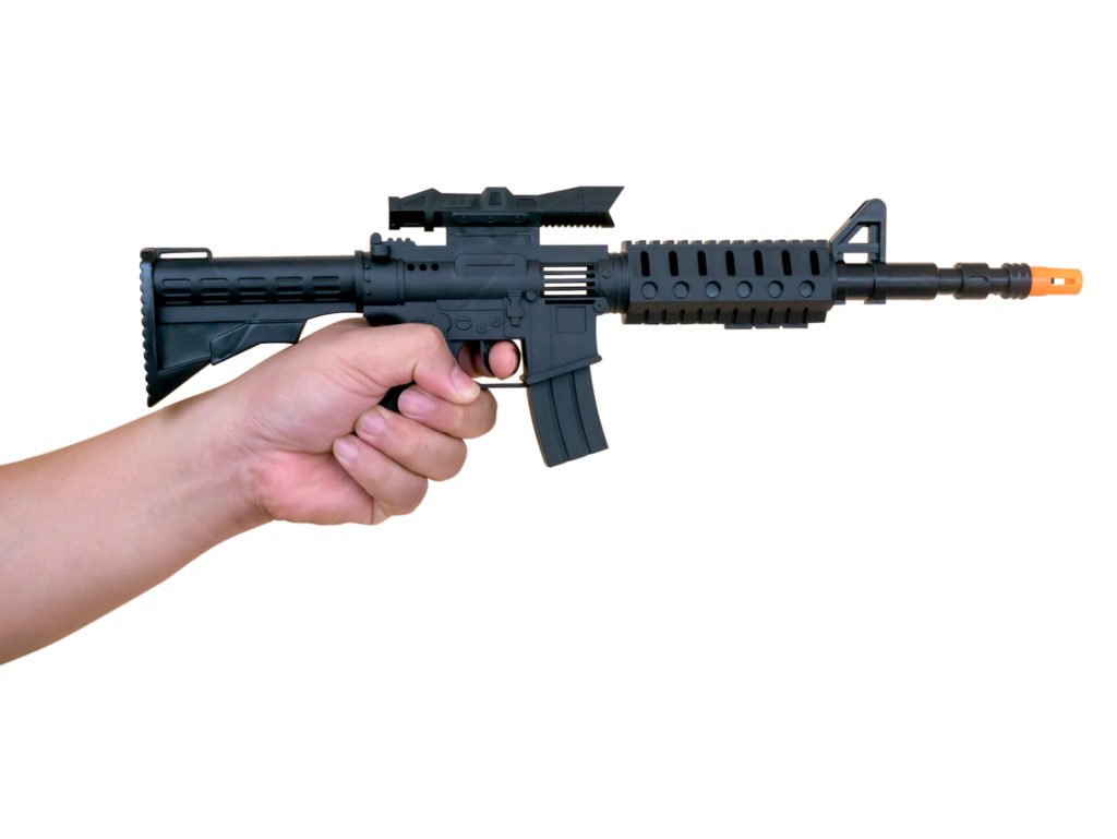 Hand holding toy rifle