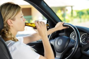 Woman drinking a beer during her second DUI