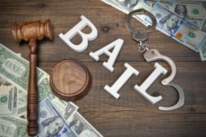 gavel, cash, and letters spelling out BAIL