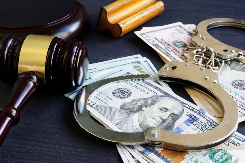 gavel, cash, stamp, and cuffs to illustrate a scenario where a 1275 hold might be imposed