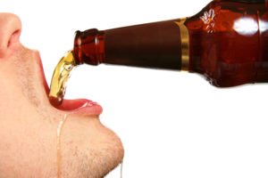 Man drinking from a beer bottle