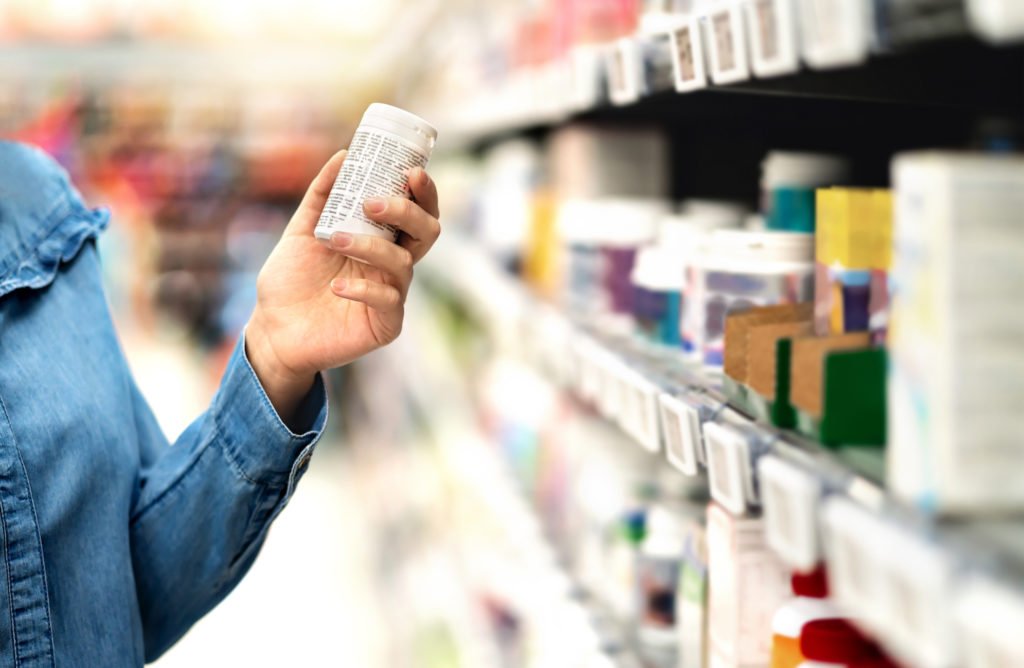 Close up of woman's hand holding prescription bottle