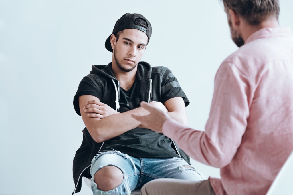 Counselor talking to troubled young man