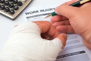 Hand in cast filling out workers comp claims form