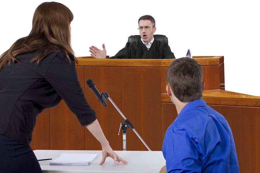 Defendant and attorney in courtroom talking to judge