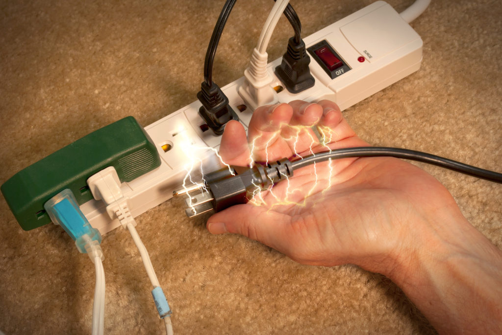 Power strip with hand holding plug with electric shock