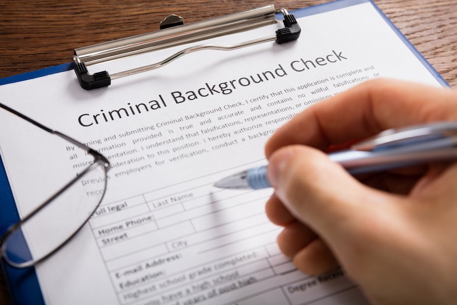 Clipboard with paper that says criminal background check