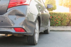 Car with dented bumper after hit and run
