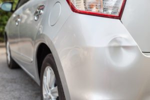 Car with dented fender after hit and run