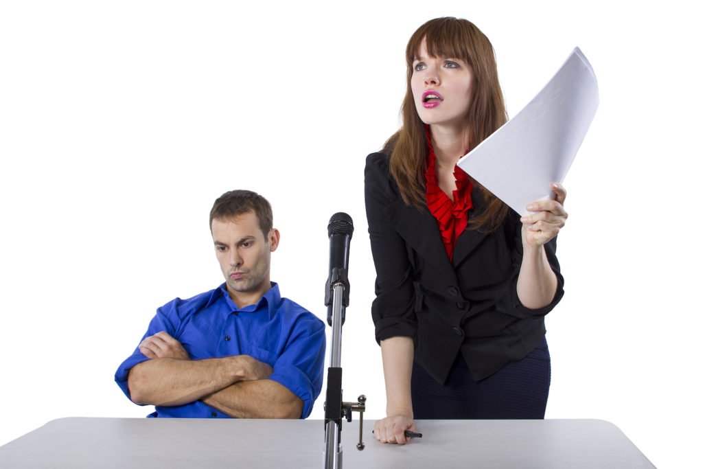Angry attorney with her client in court - malicious prosecution in California can be the basis for a lawsuit in Court