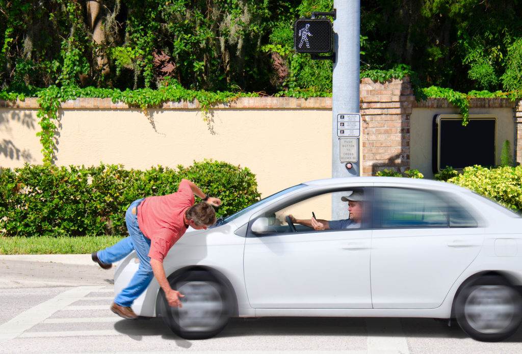 Driver of small car striking pedestrian at crosswalk