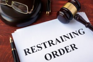 Paper that says "restraining order" with a gavel