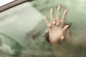 Two hands pressed against window glass
