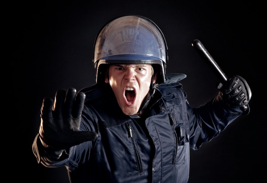 Angry police officer with nightstick