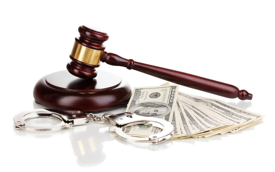 Judge's gavel, handcuffs, and cash bail
