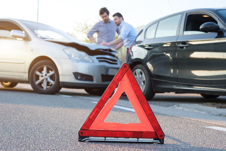 Rear-end accident with drivers looking at the damage