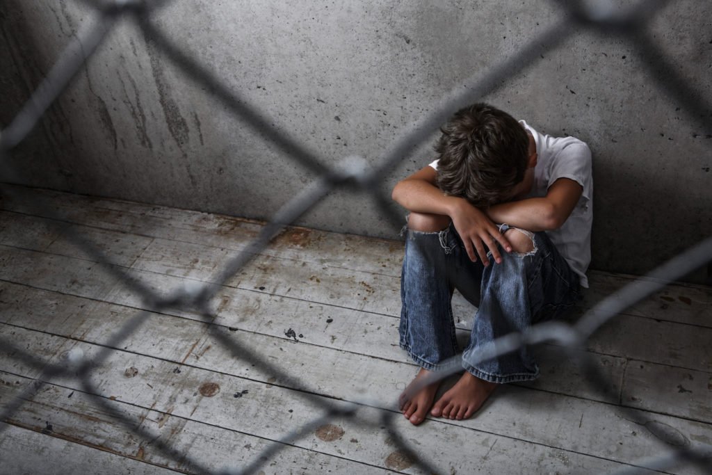 Joven sentado en una instalación de detención