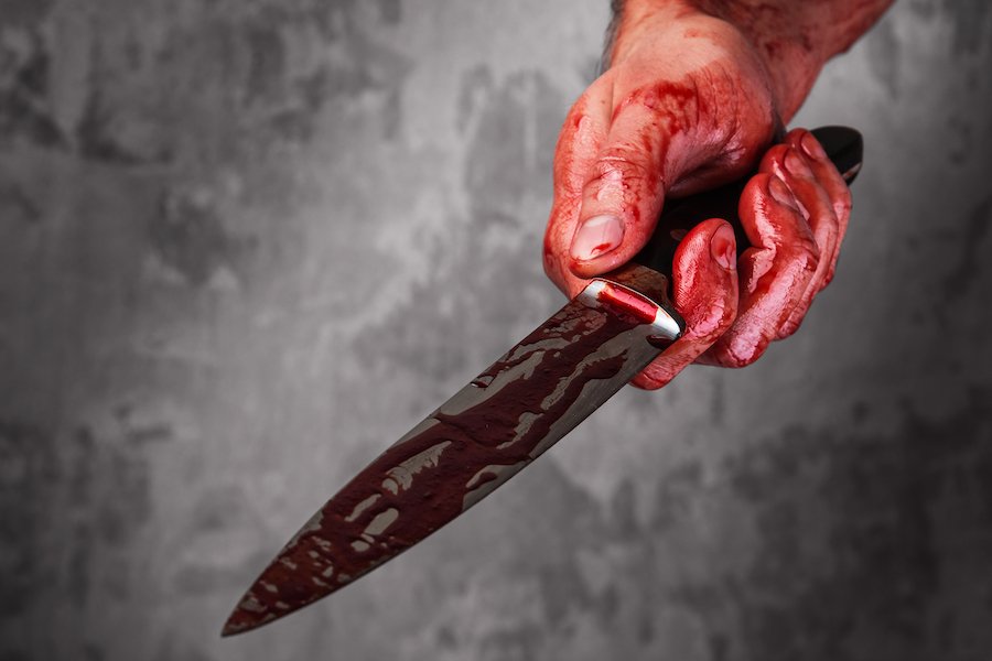 Hand holding a bloody knife