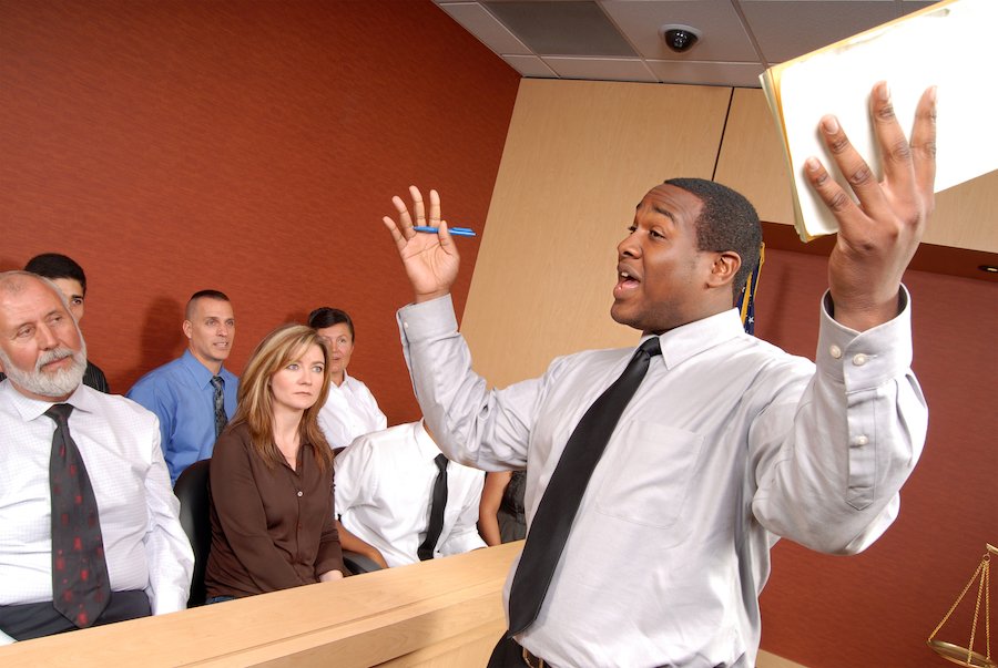 Criminal defense attorney in front of jury arguing for client - a good drug crimes lawyer knows how to convince jurors