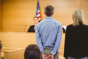 Defendant and attorney in courtroom waiting for judge's decision
