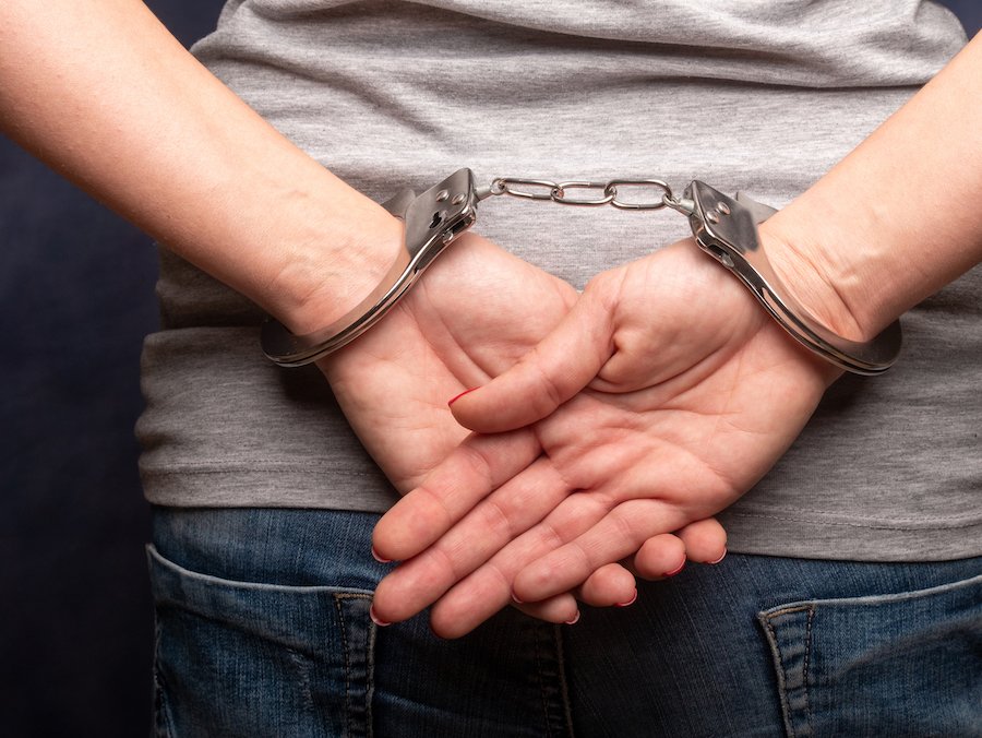 Closeup of hands in cuffs following arrest