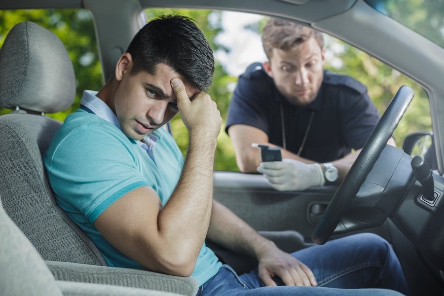 Police administering roadside breath test to DUI suspect