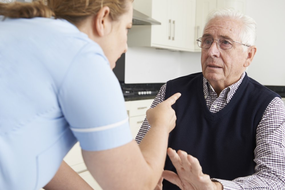 a senior being scolded by caregiver