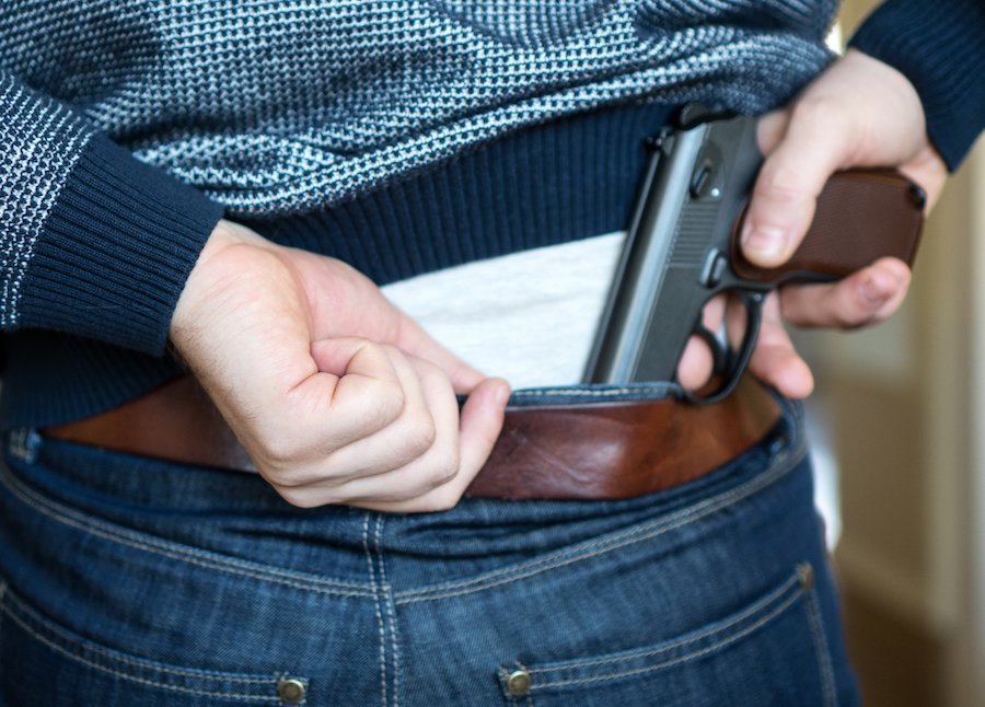 Man hiding revolver in jeans