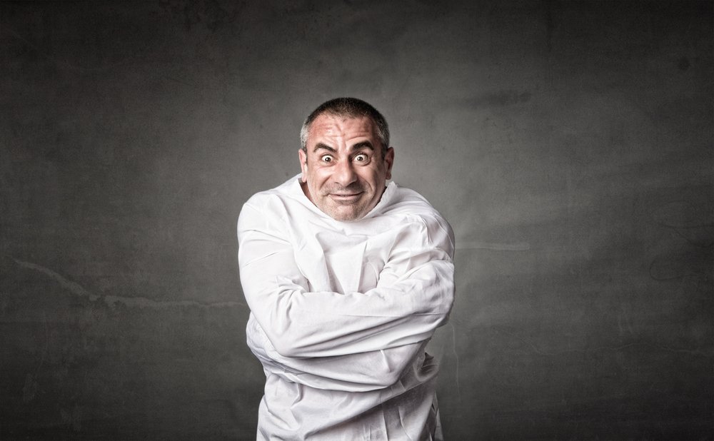 Man in a straitjacket.