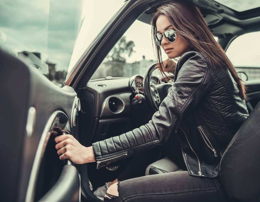 A leather clad woman getting into a car. Joyriding is illegal in Arizona.