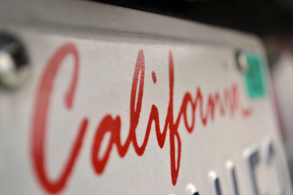 Close-up of a securely fastened California license plate.