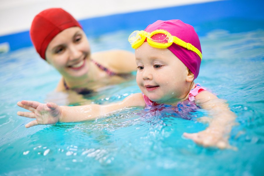 Adult supervising infant swimmer