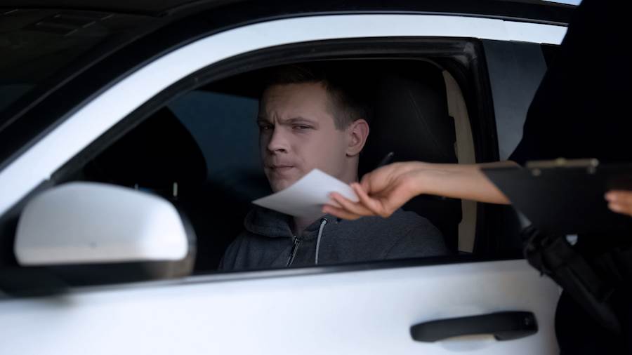 Police handing ticket to driver