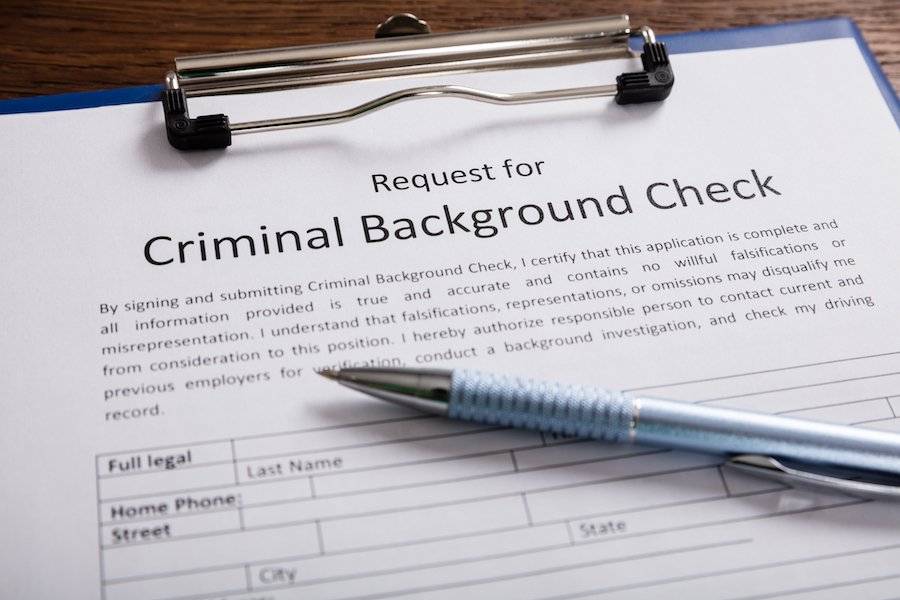 Clipboard with paper saying "criminal background check"