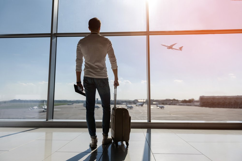 Man holding baggage at the airport.