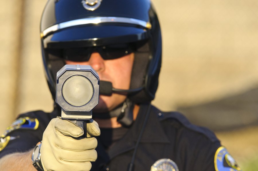 Police holding speed radar gun