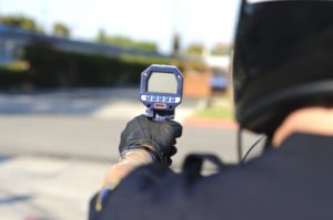 Police holding up speed detection device.